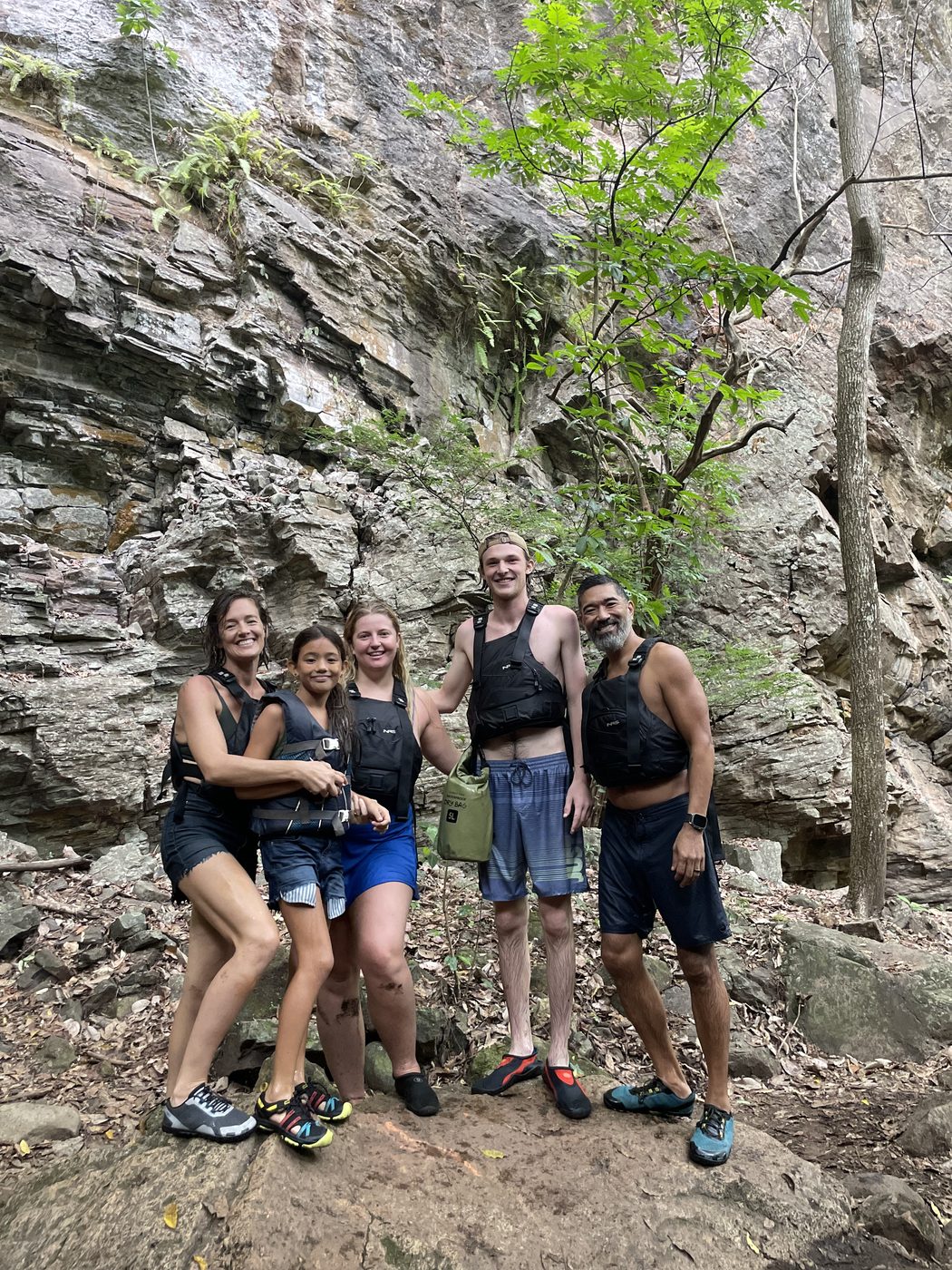 The whole family in life jackets on a river trip