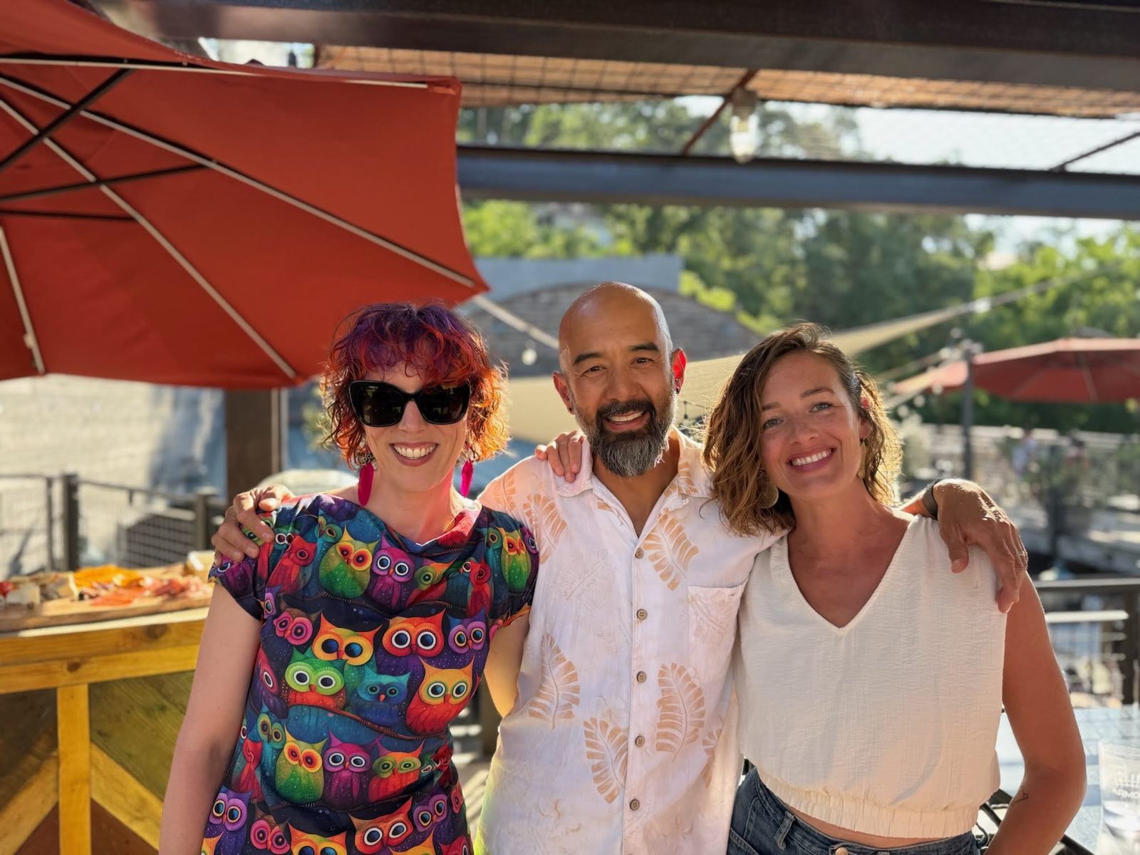 Cassie and Derek with a friend on a patio