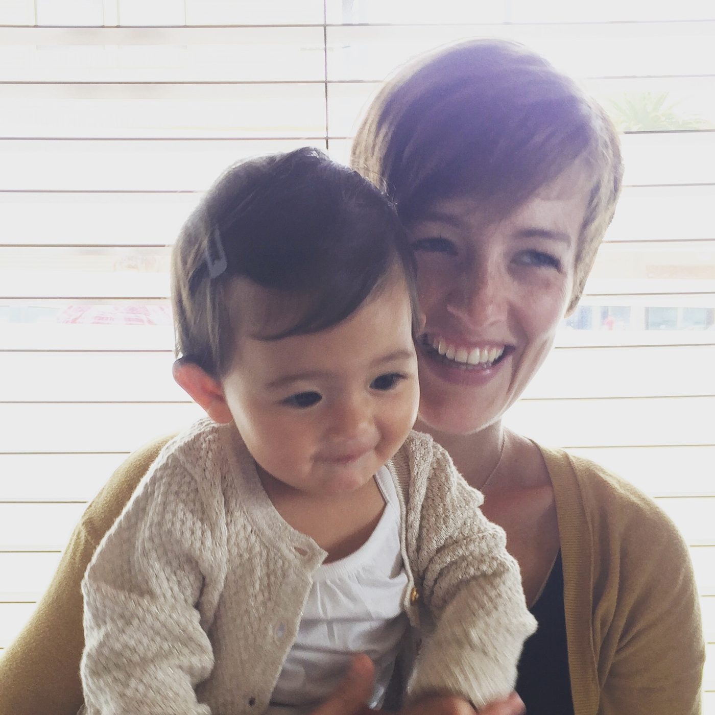 Cassie with purple hair, holding her daughter as a baby